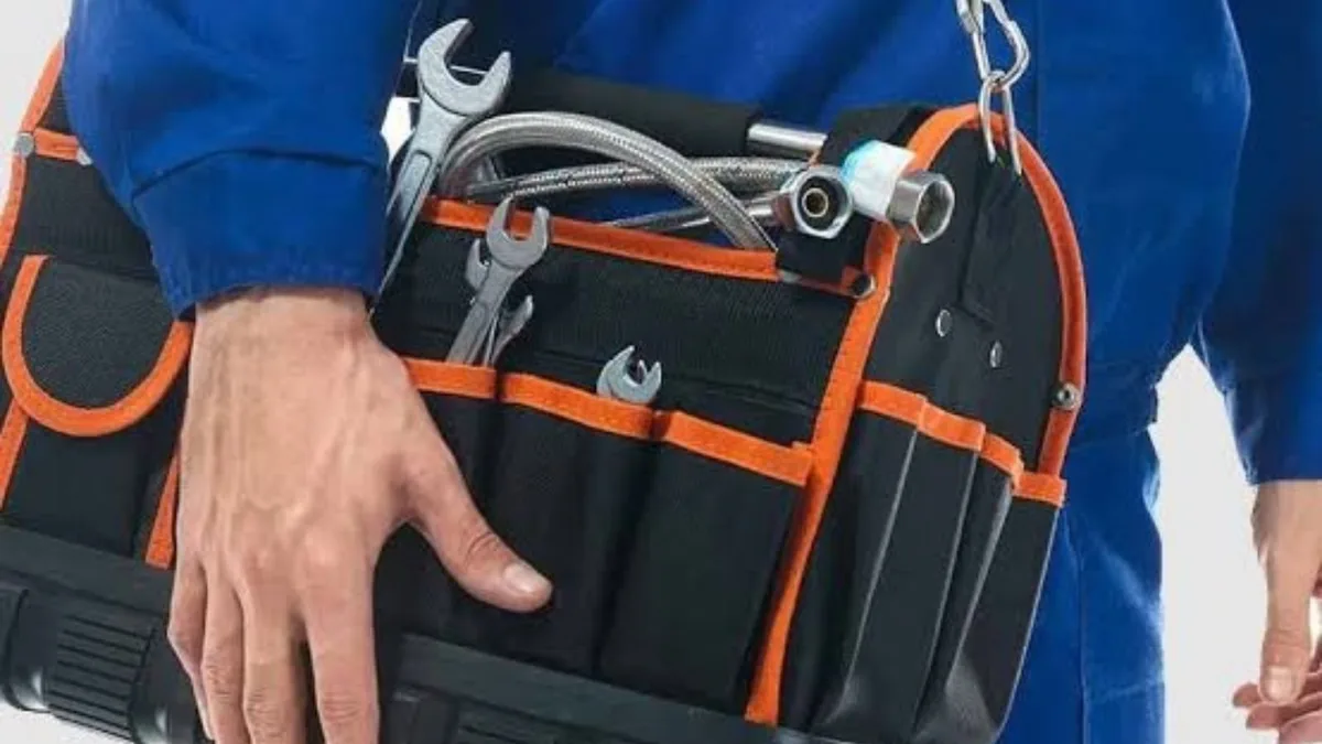 Plumber's tool bag with wrenches and a supply line, ready for a Sun City, AZ service call