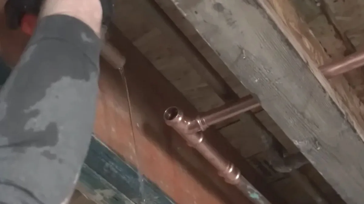 Plumber repairing a burst pipe in a Sun City, AZ home