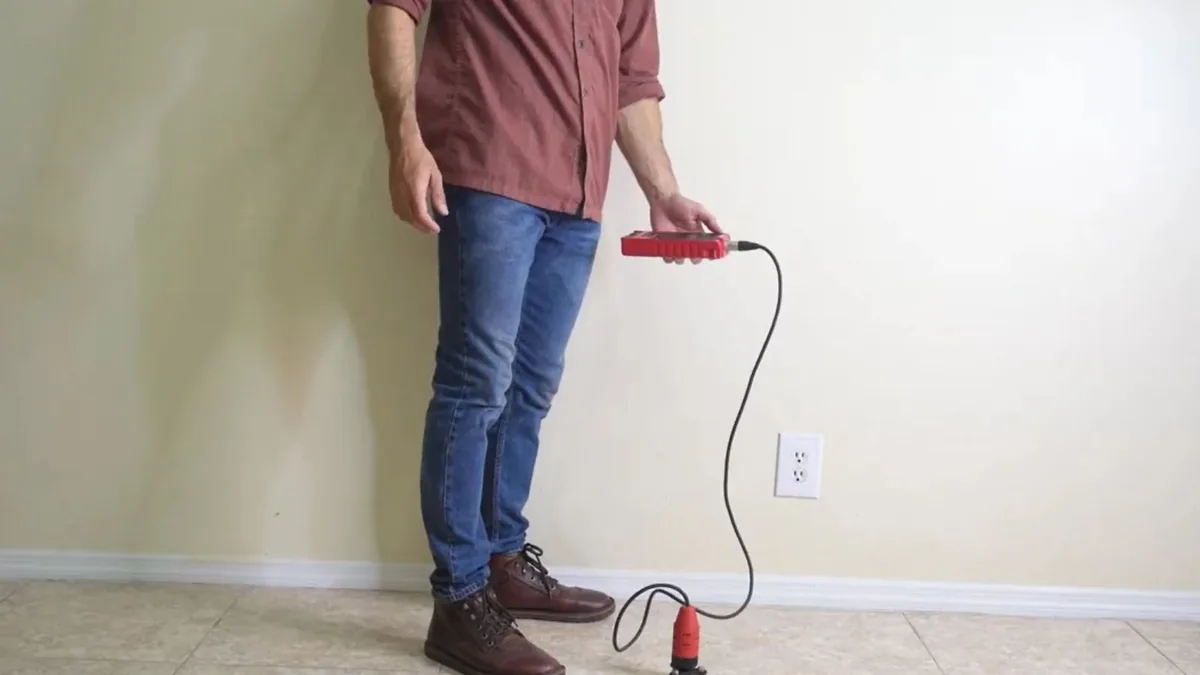 Plumber using electronic leak detection equipment on a floor in Sun City, AZ