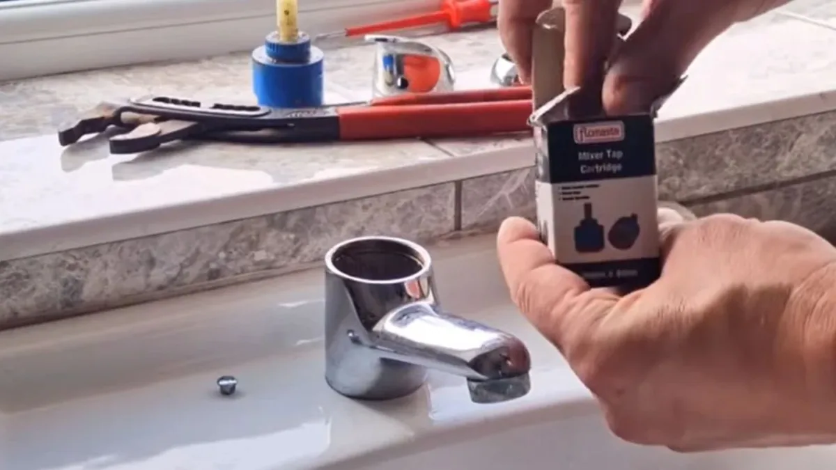 Plumber repairing a kitchen faucet in a Sun City, AZ home