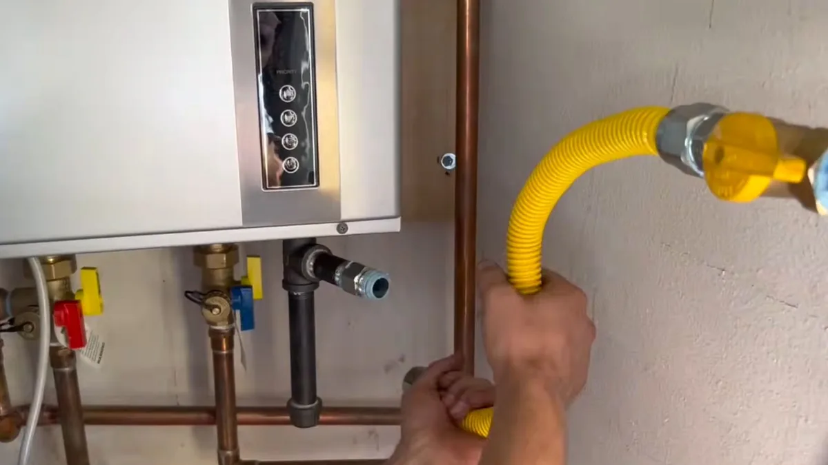 Wall-mounted tankless water heater unit being serviced in a Sun City, AZ home