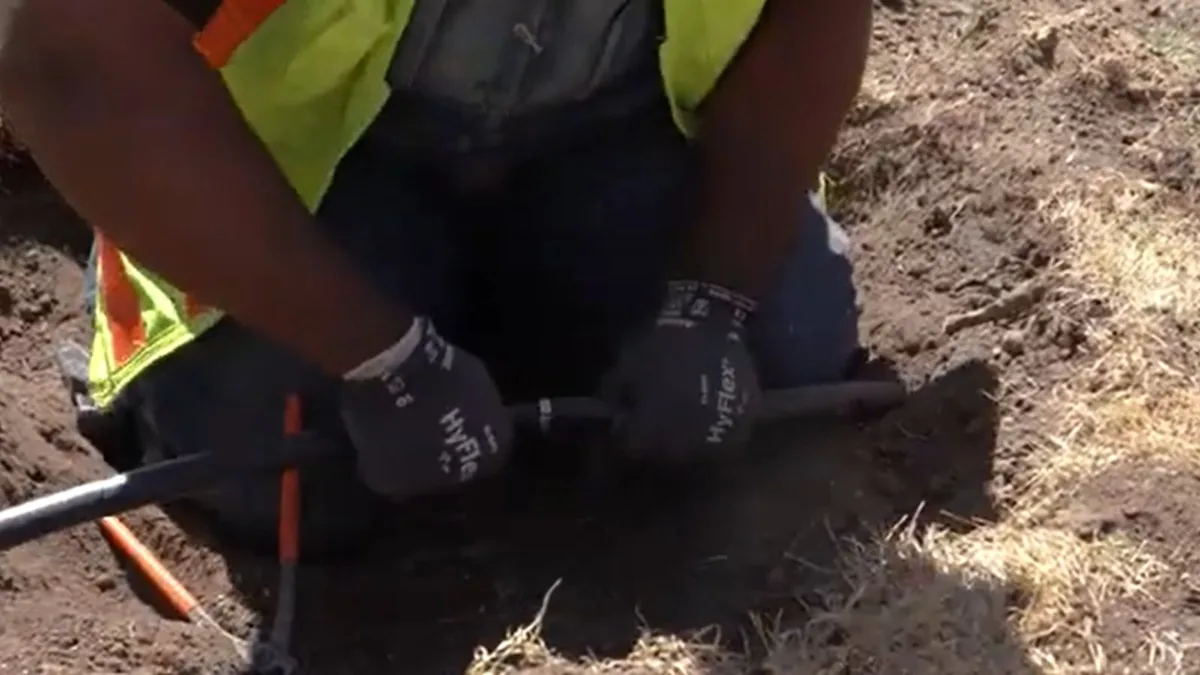 Plumber repairing a water service line in a Sun City, AZ yard